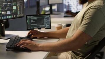 Portrait of smiling machine learning infrastructure engineer developing algorithms to learn from data. Cheerful man in office training and deploying large scale deep learning models, camera A video