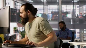 Annoyed programmer at work raging after losing all progress due to computer crash while creating machine learning models. Angry IT worker smashing desk in frustration while programming, camera A video