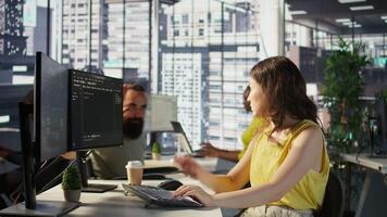 Cheerful manager in wheelchair doing high five with employee testing machine learning software. Team leader with disability saluting worker, doing friendly gesture, camera B video