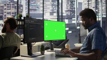 Programmer utilizing green screen computer to train machine learning models, zoom in shot. Close up of mockup PC used by IT expert monitoring and maintaining company systems, camera B video