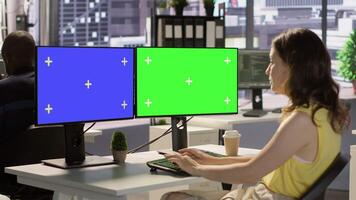 Developer using multi monitor isolated screen PC to create machine learning models that can process data to automate decision making processes. Woman programming using mockup computer, camera A video