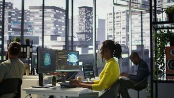 Computer scientist testing AI company software, identifying errors in machine learning tech. African american IT staff member writing artificial intelligence code in programming language, camera B video