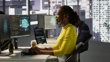 Computer scientist testing AI company software, identifying errors in machine learning tech. African american IT staff member writing artificial intelligence code in programming language, camera A video