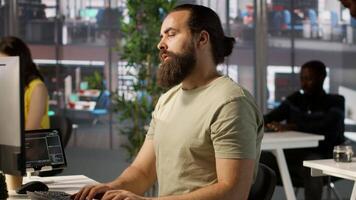 Employee using computer to analyze datasets, being assisted by helpful coworker on comparing accounting figures. Man helped by department colleague to solve tasks for team project, camera A video