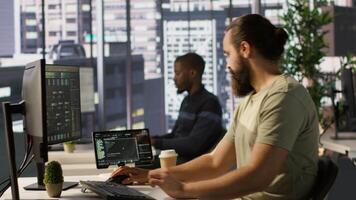 System administrator checking results on tablet after creating complex machine learning models that can process and analyze vast amounts of data. Admin standing in office, looking at device, camera A video