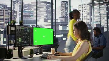 Admin using multi monitor green screen PC to create machine learning models that can process data to automate decision making processes. Woman programming using chroma key computer video