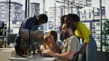 Team of software engineers doing brainstorming to create machine learning models that can process and analyze data to improve decision making processes. Colleagues working together in office, camera B video