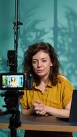 Vertical Content creator using professional camera to shoot intro for vlog channel on online platforms. Internet star warmly welcoming dedicated fanbase, recording with advanced gear, camera A video