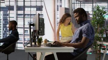 African american man designing, developing and maintaining software applications using various programming languages. System administrator debugging company servers, preventing failures, camera A video