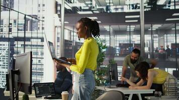 System administrator creating machine learning models that can process and analyze data to automate decision making processes. IT staff member using laptop to do programming in office, camera B video