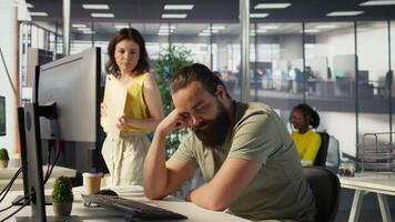 Exhausted developer caught asleep at desk by manager while developing AI machine learning company tech. Supervisor waking up tired sleeping employee while training predictive models, camera B video