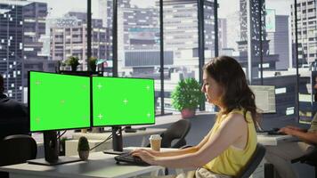 Developer using multi monitor isolated screen PC to create machine learning models that can process data to automate decision making processes. Woman programming using mockup computer, camera B video