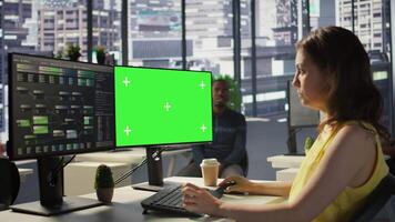 Computer scientist working, doing software debugging using mockup PC, troubleshooting errors. Woman in office fixing coding issues using green screen computer, solving tasks, camera B video