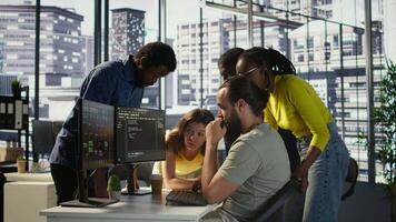 Programmers gathered together to conduct code review to fix errors, identifying technical issues with company software. Team of developers doing brainstorming, optimizing code, camera B video