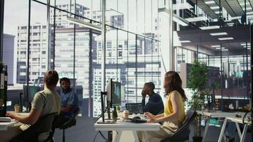 Manager discussing with employees in office, developing artificial intelligence machine learning APIs. Team leader doing brainstorming with workers, training AI predictive models, camera B video