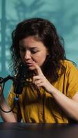 Vertical Content creator preparing podcast recording equipment, waiting for guests to arrive and film . Online show host testing professional microphone before conducting interviews in studio, camera B video