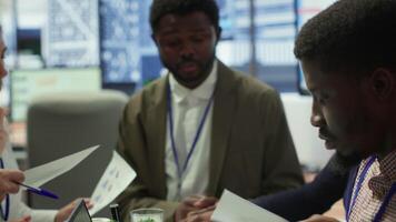Enterprise manager works with his staff on creating a business strategy and setting goals, studying market dynamics and sales numbers. Corporation team attends a development meeting. Camera A. video