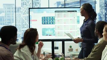 Employees team analyzing infographics to offer solutions for new project, looking to finish tasks before deadline. Enterprise coworkers attending problem solving conference in boardroom. Camera A. video