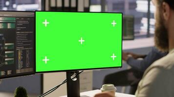 Man working with machine learning tech on green screen computer, advancing AI innovating autonomous systems, close up. Zoom in on mockup PC monitor used by IT expert in office, camera A video
