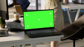 Focus on chroma key laptop in workspace used by computer scientists doing software debugging. Close up of isolated screen notebook used by workers in office fixing coding issues, camera A video