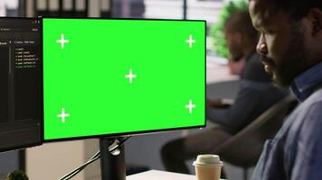 Programmer utilizing green screen computer to train machine learning models, zoom in shot. Close up of mockup PC used by IT expert monitoring and maintaining company systems, camera A video