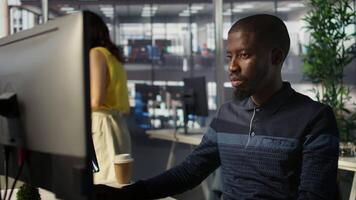Upbeat software engineer utilizing cloud computing resources to train and deploy large scale machine learning models. Jolly man monitoring company systems, ensuring their reliability, camera B video