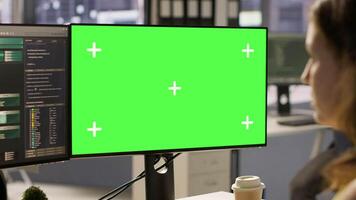 Computer scientist working, doing software debugging using mockup PC, troubleshooting errors. Woman in office fixing coding issues using green screen computer, solving tasks, camera A video