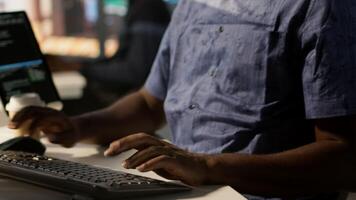 Man doing data entry, typing on keyboard on PC, solving tasks. Close up of office clerk in workspace making sure documents are compliant with quality assurance expectations and standards, camera A video