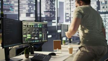 Programmer developing machine learning APIs solving complex problems, checking performance on tablet. Man training predictive models capable of handling resource intensive tasks, camera B video