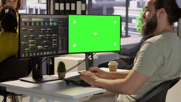 Computer scientist using isolated screen PC to create machine learning models that can process data to automate decision making processes. IT specialist programming using chroma key computer, camera A video