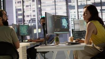 Manager discussing with employees in office, developing artificial intelligence machine learning APIs. Team leader doing brainstorming with workers, training AI predictive models, camera A video