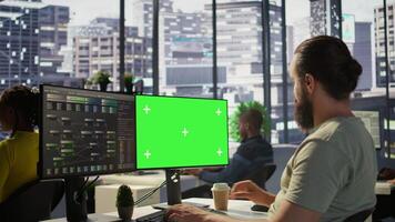 Man working with machine learning tech on green screen computer, advancing AI innovating autonomous systems, close up. Zoom in on mockup PC monitor used by IT expert in office, camera B video