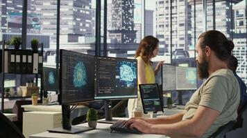 Employee utilizing AI resources and platforms to train and deploy machine learning models, handheld camera shot. Man monitoring and maintaining artificial intelligence company systems, camera B video
