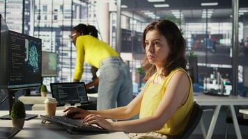 Admin tests on computer and tablet to optimize artificial intelligence machine learning models for performance and accuracy. IT worker in office analyzing and interpreting complex AI data, camera B video