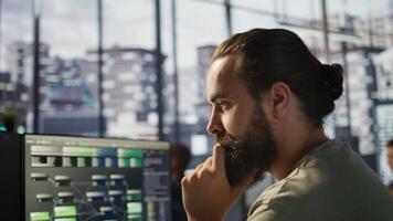 System administrator working with machine learning artificial intelligence critical to autonomous systems. Close up of man transforming data into predictive models, camera B video