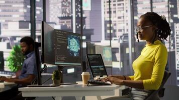 Software engineer conducts code review to fix bugs, identifying technical issues with artificial intelligence company software. African american woman debugging and optimizing code using AI, camera A video
