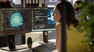 Employee using AI technology to design algorithms that enable machines to learn from data. Admin in office training large scale deep learning models with artificial intelligence tech, camera A video