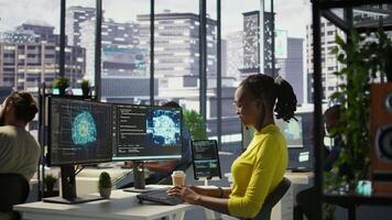 Software engineer conducts code review to fix bugs, identifying technical issues with artificial intelligence company software. African american woman debugging and optimizing code using AI, camera B video