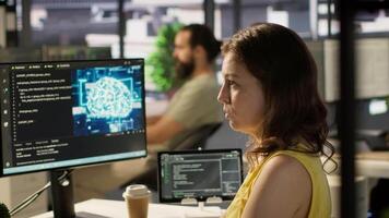 System administrator at work doing debugging of AI software using PC, checking glitches in lines of code. IT specialist in office fixing artificial intelligence coding issues using computer, camera A video