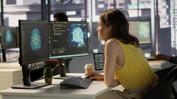Admin and coworker conducting experiments and tests to optimize AI machine learning models for performance and accuracy. Team of IT experts in office analyzing artificial intelligence data, camera A video