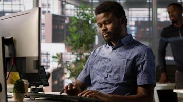 Admin assisted by coworker, working with machine learning artificial intelligence critical to autonomous systems. IT staff members working together to transform data into predictive models, camera A video