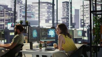 Employee using AI technology to design algorithms that enable machines to learn from data. Admin in office training large scale deep learning models with artificial intelligence tech, camera B video
