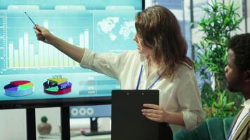 Employees team analyzing infographics to offer solutions for the new project, looking to finish tasks before deadline. Enterprise coworkers attending problem solving conference in boardroom. Camera A. video