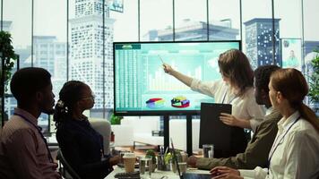 Employees team analyzing infographics to offer solutions for the new project, looking to finish tasks before deadline. Enterprise coworkers attending problem solving conference in boardroom. Camera B. video