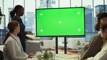 Employees and investors participating in a briefing next to isolated copy space display, reviewing economic indicators and performance metrics. Work team discussing finance planning. Camera A. video