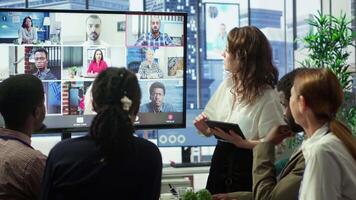 Business team in a boardroom attend videocall meeting with investors group, discussing about increasing funds for a global development plan. Staff and shareholders on teleconference. Camera A. video