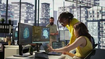 Admin assisted by coworker while utilizing cloud computing resources to train large scale machine learning models. Woman and colleague monitoring AI company systems using computer, camera B video