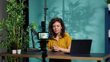 Content creator using professional camera to shoot intro for vlog channel on online platforms. Internet star warmly welcoming dedicated fanbase, recording with advanced gear, camera A video