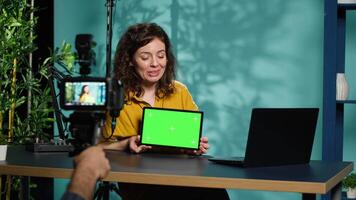 Tech guru excited to review newly released chroma key tablet, comparing features with older models. Influencer filming , analyzing latest generation of green screen digital device, camera A video