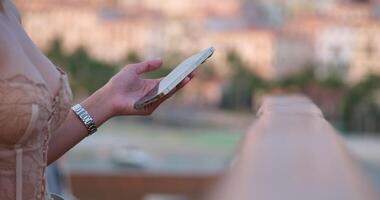 phone in hands Focus on manager using smart phone standing over night city street. Woman using smart phone manager using smart phone posting social media, online shopping, tracking shot video